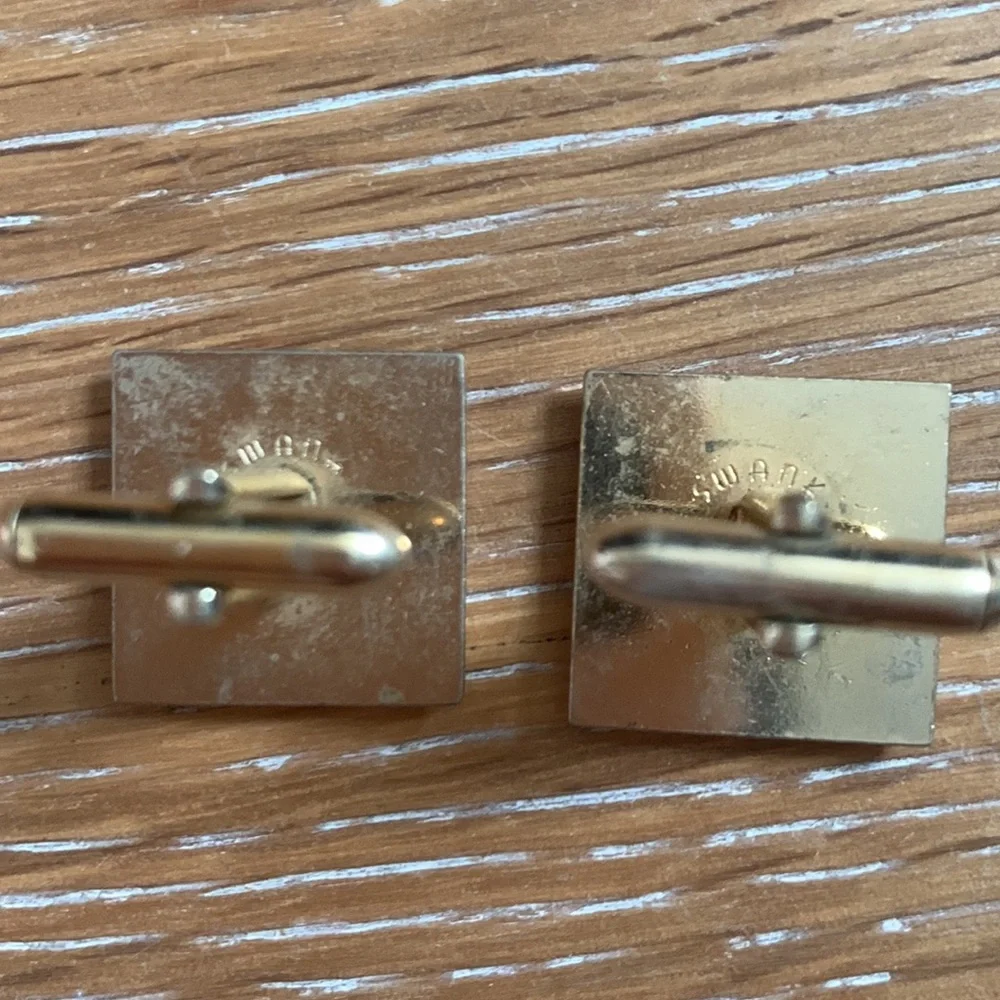 gold cuff links with silver and black accents